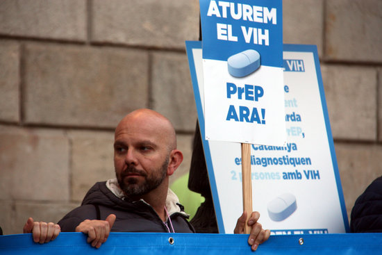 A man at the 2016 World AIDS day march in Barcelona demanding access to PrEP (by Elisenda Rosanas)